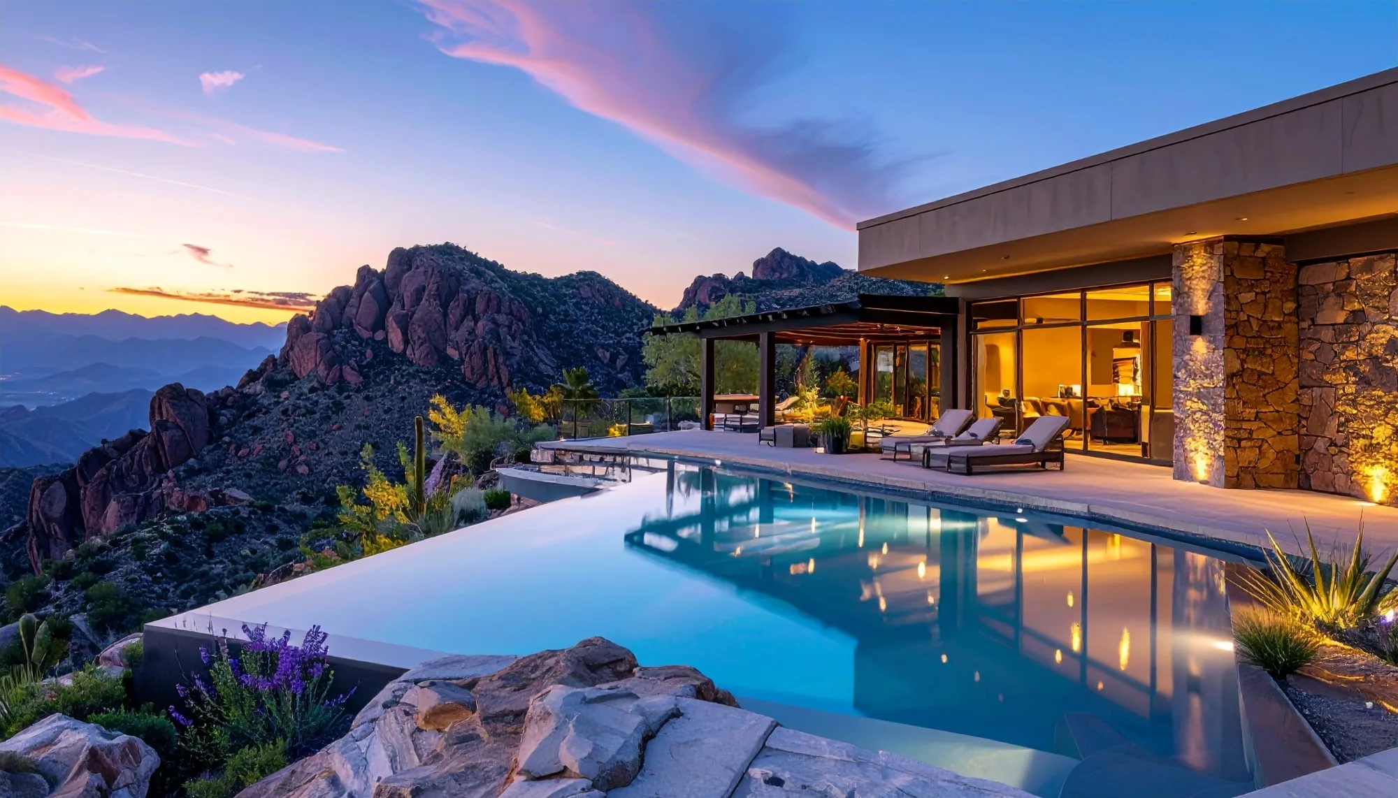 Luxury cliffside desert home with an infinity pool at dusk.